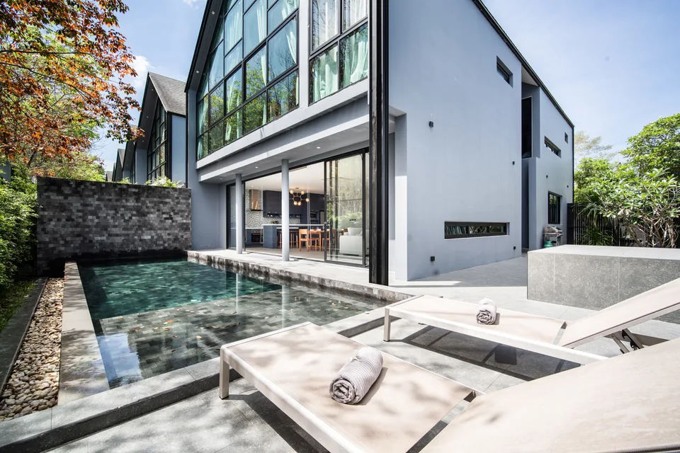 The courtyard, private pool and glazed villa facade