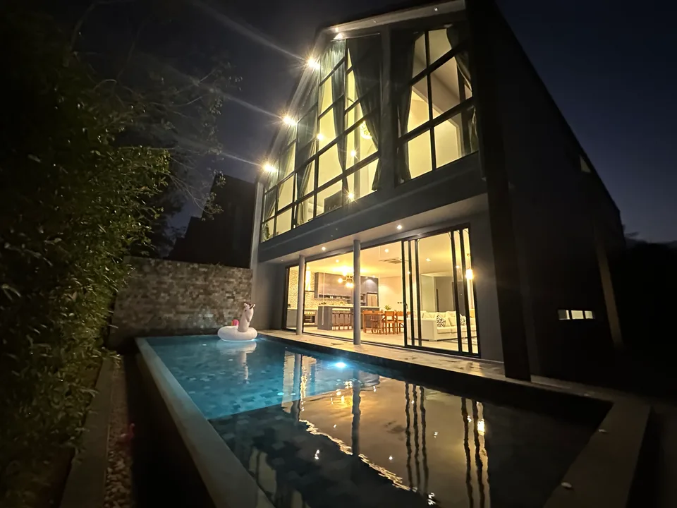 The villa and pool after dark